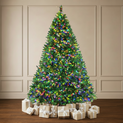 A tall artificial Christmas tree with green branches, decorated with multicolored lights and ornaments, standing on a dark wood floor against a beige paneled wall.